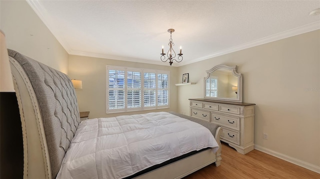 bedroom with light hardwood / wood-style floors, an inviting chandelier, and crown molding