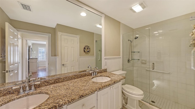 bathroom with vanity, toilet, and walk in shower