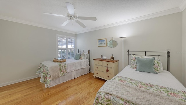 bedroom with ceiling fan, light hardwood / wood-style floors, and crown molding