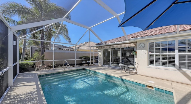 view of swimming pool with a lanai and a patio area