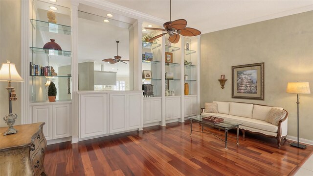 7575 Quinto Dr, Sarasota, FL 34238 - sitting room with built in shelves, ceiling fan, ornamental molding, and dark hardwood / wood-style flooring