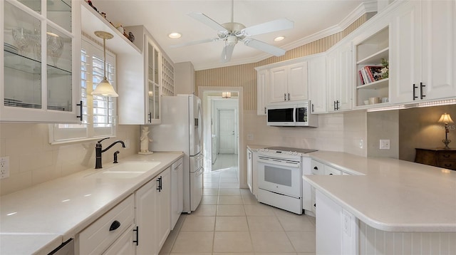 7575 Quinto Dr, Sarasota, FL 34238 - kitchen with light tile patterned flooring, pendant lighting, white cabinetry, sink, and white appliances