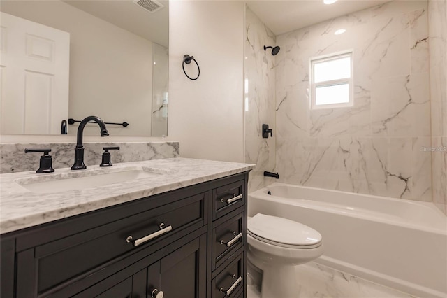 full bathroom with vanity, toilet, and tiled shower / bath