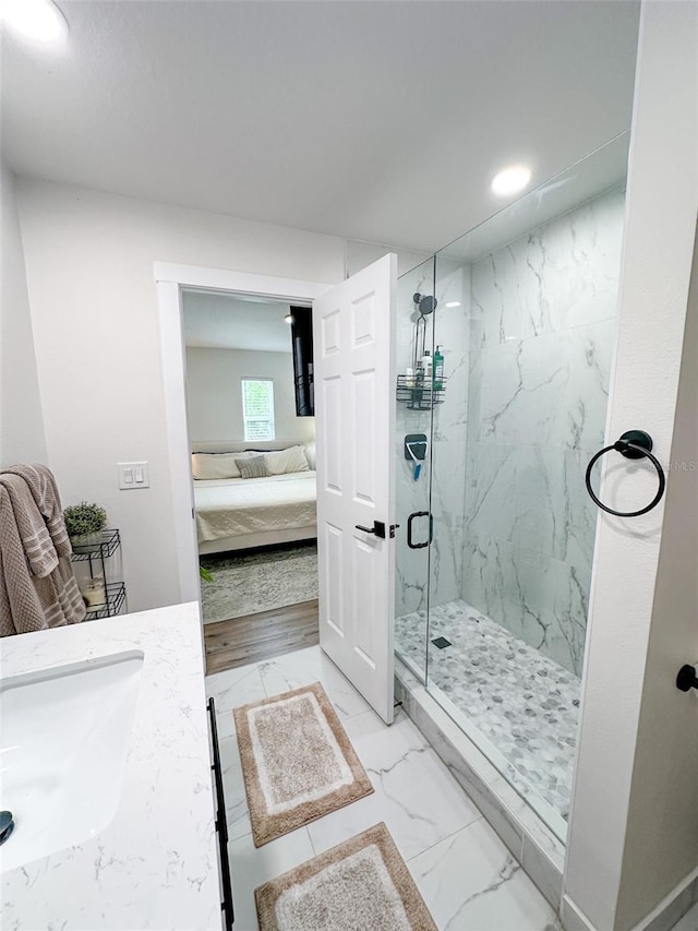 bathroom with vanity and a shower with shower door