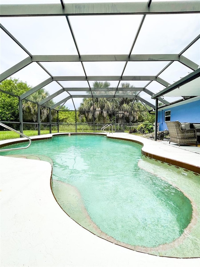 view of swimming pool with a lanai and a patio