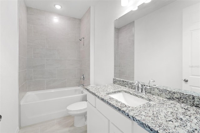 full bathroom with toilet, vanity, and tiled shower / bath combo