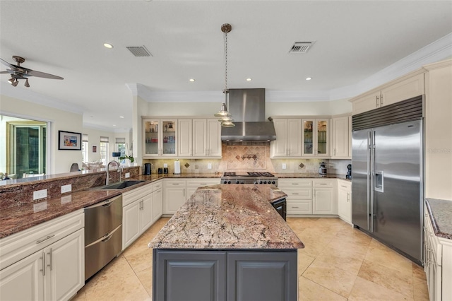 kitchen with ventilation hood, dark stone counters, hanging light fixtures, a center island, and stainless steel appliances