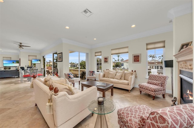 living room featuring crown molding, a wealth of natural light, and ceiling fan