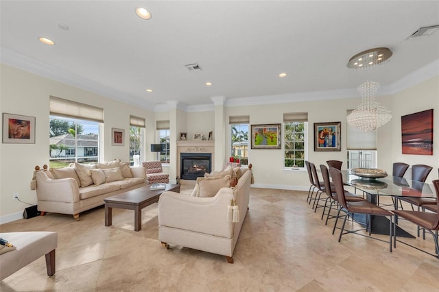 living room featuring ornamental molding and a notable chandelier