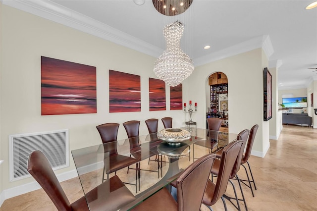 dining room with crown molding and an inviting chandelier