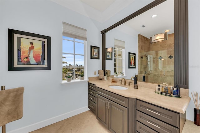 bathroom with a shower with door, vanity, tile patterned floors, and crown molding