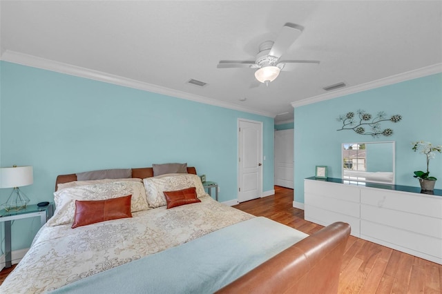 bedroom with hardwood / wood-style floors, ornamental molding, and ceiling fan