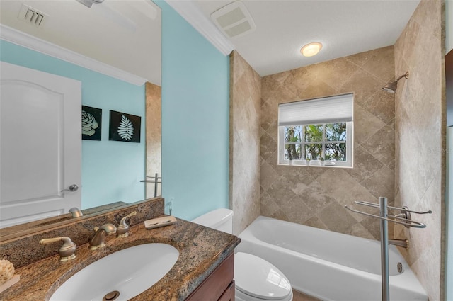 full bathroom with crown molding, vanity, toilet, and tiled shower / bath combo