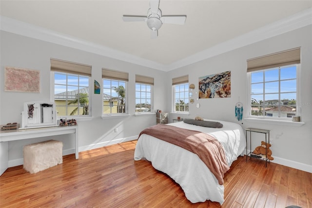 bedroom featuring crown molding, ceiling fan, and light hardwood / wood-style flooring