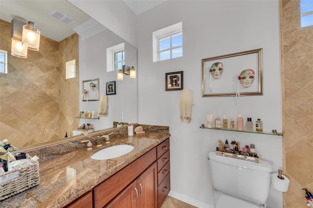 bathroom featuring vanity, ornamental molding, and toilet