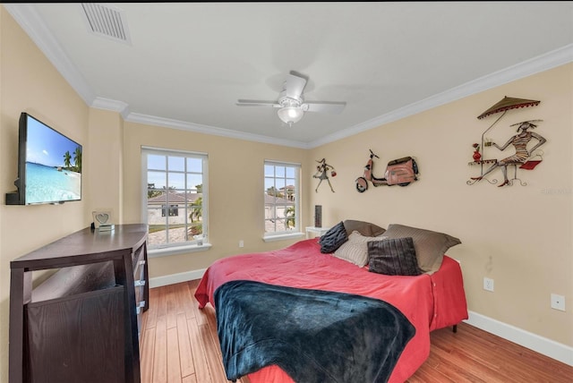 bedroom with crown molding, ceiling fan, and wood-type flooring