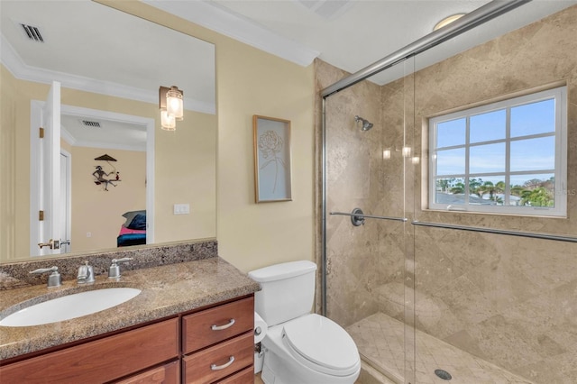 bathroom featuring vanity, toilet, crown molding, and walk in shower