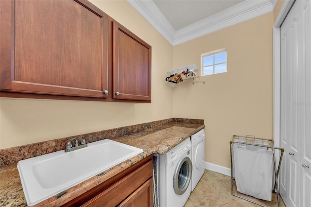 laundry room featuring sink, washer and clothes dryer, ornamental molding, and cabinets