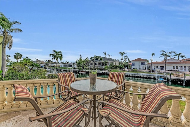 balcony with a water view and a boat dock