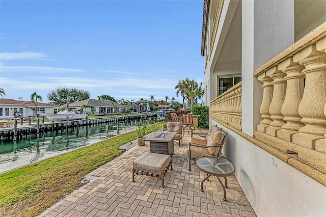 view of patio / terrace with an outdoor fire pit and a water view