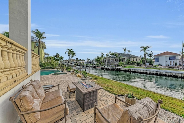 view of patio / terrace featuring a fire pit and a water view