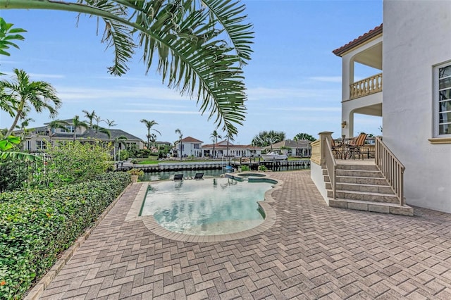 view of swimming pool with an in ground hot tub