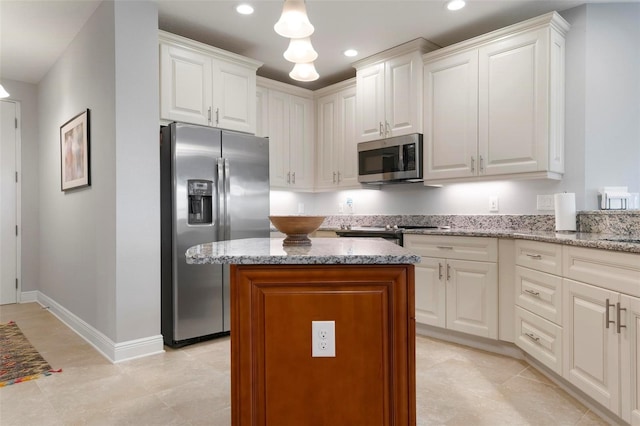 kitchen featuring light stone counters, white cabinets, and appliances with stainless steel finishes