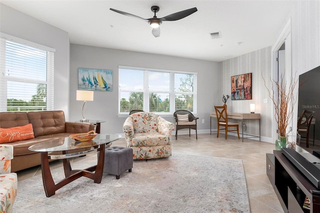 living room with ceiling fan and light tile patterned floors