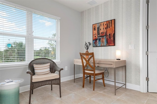 sitting room featuring plenty of natural light and light tile patterned floors