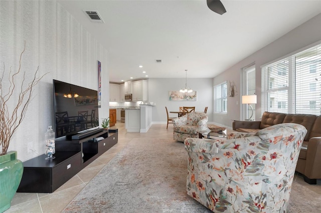 living room featuring light tile patterned floors and a notable chandelier