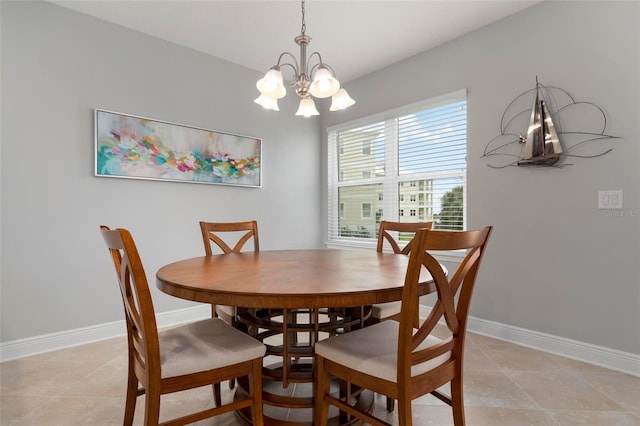 tiled dining space featuring a chandelier