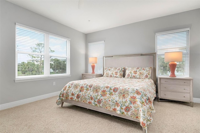 bedroom with carpet and multiple windows