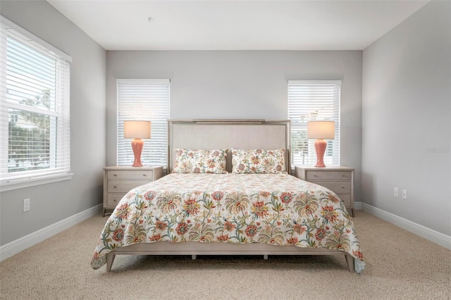 carpeted bedroom with multiple windows