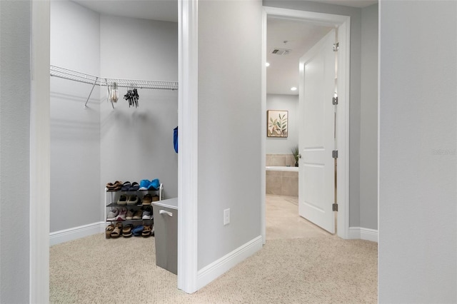 hallway featuring light carpet