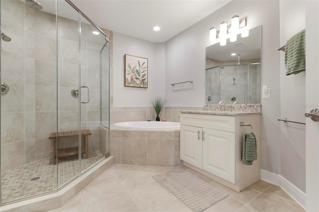 bathroom featuring independent shower and bath, tile patterned flooring, and vanity