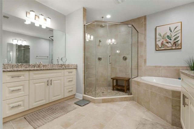 bathroom featuring tile patterned floors, vanity, and separate shower and tub