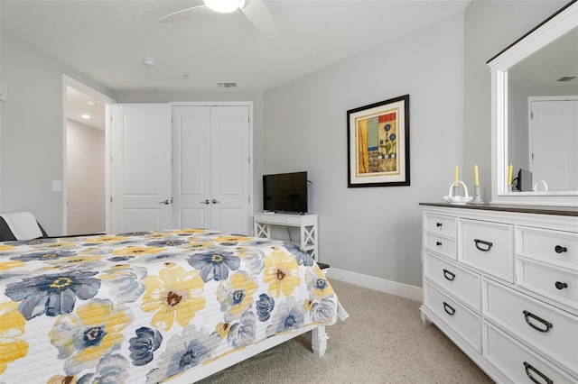 carpeted bedroom with ceiling fan and a closet