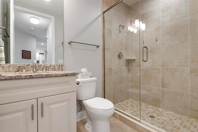 bathroom featuring an enclosed shower, vanity, and toilet