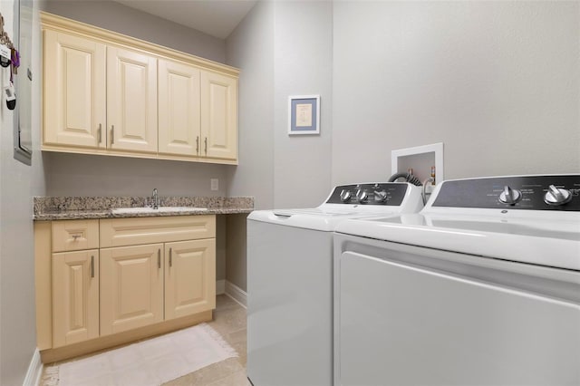 clothes washing area with cabinets, sink, washer and clothes dryer, and light tile patterned flooring