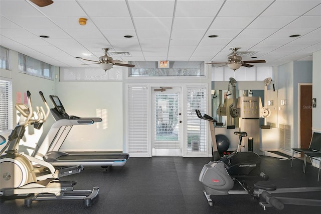 gym with ceiling fan and a paneled ceiling