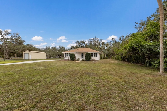 single story home with a garage and a front yard