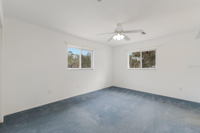 carpeted spare room with ceiling fan