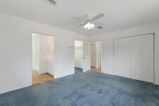 unfurnished bedroom with ceiling fan, connected bathroom, and light carpet