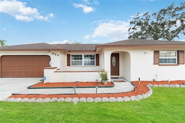 single story home featuring a garage and a front yard