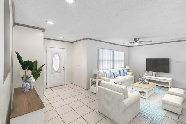 living room with crown molding, ceiling fan, light tile patterned flooring, and a textured ceiling