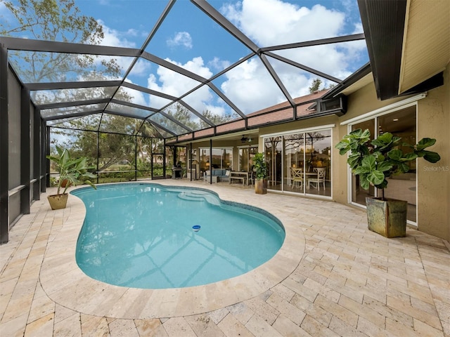 view of swimming pool featuring a patio and glass enclosure