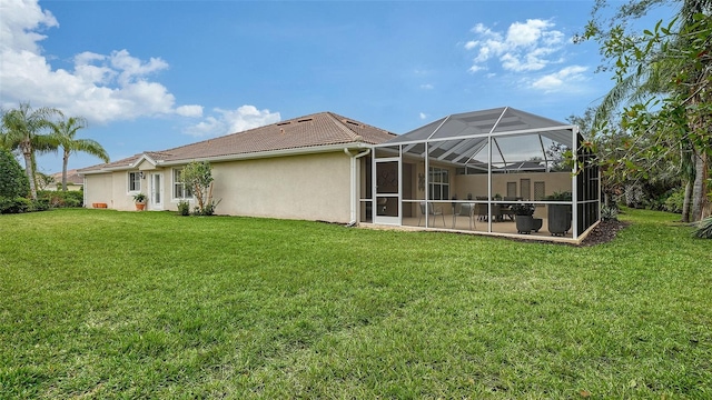 back of house featuring a lanai, a yard, and a patio