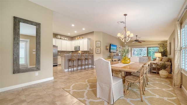 dining room featuring ceiling fan, light tile patterned floors, and lofted ceiling