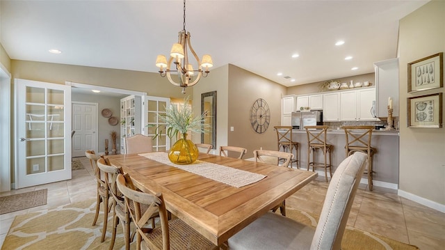 tiled dining area featuring lofted ceiling and a chandelier