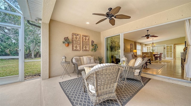 sunroom featuring ceiling fan and lofted ceiling